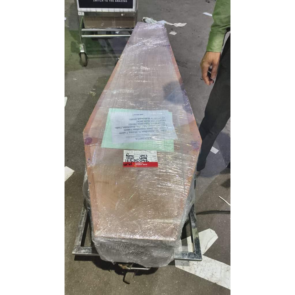 Wrapped coffin placed on airport trolley for dead body transportation by air in India